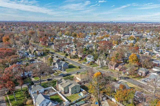 an aerial view of residential houses with city view
