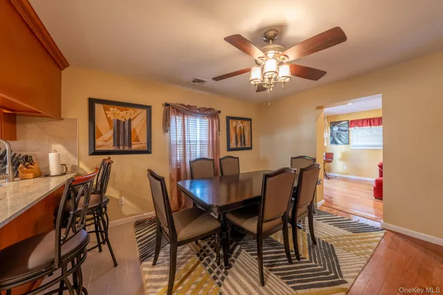 a view of a dining room with furniture and chandelier