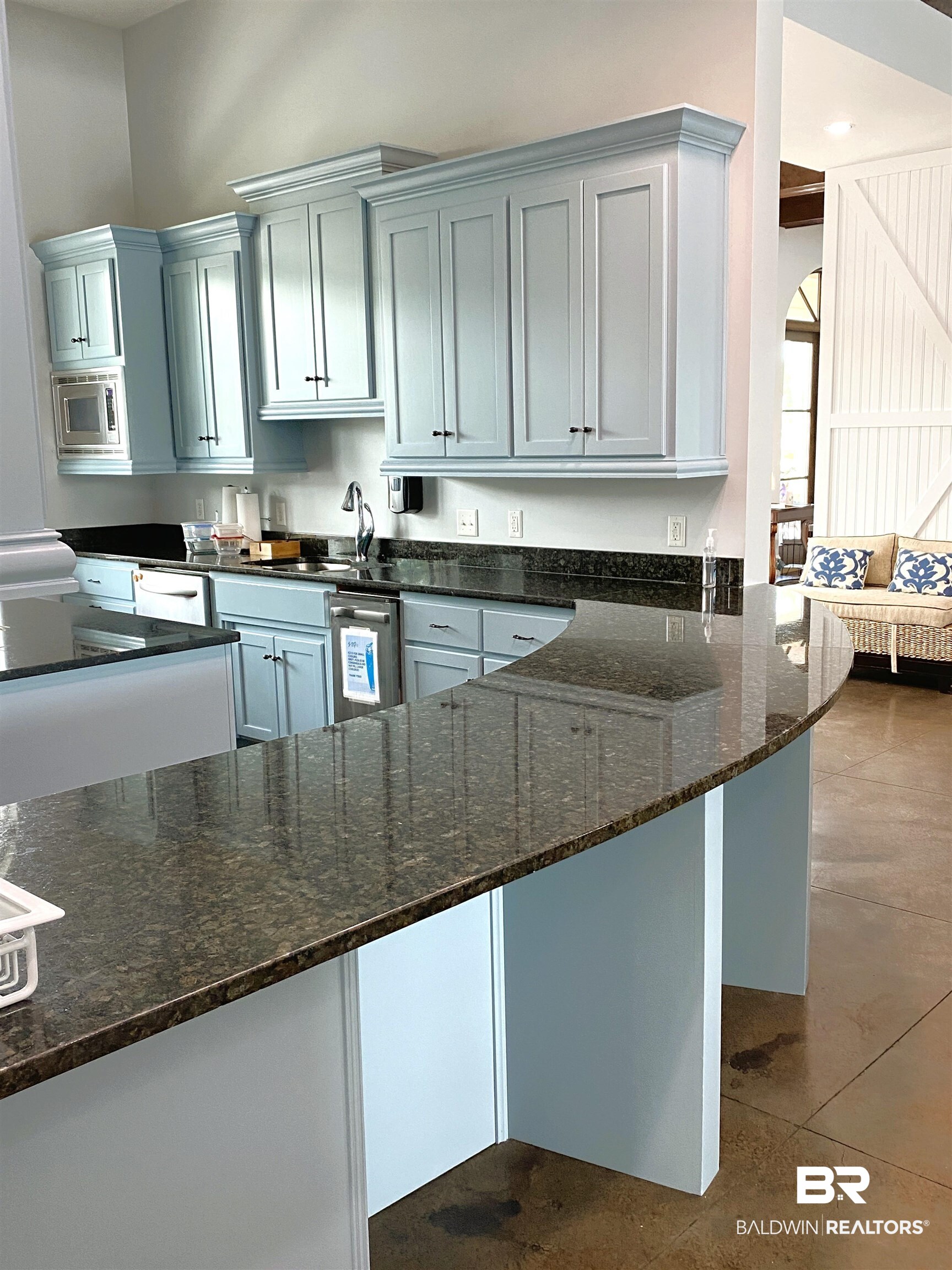 28086 Migratory Way Elberta, AL 36530 - Photo 43 of 46 Kitchen featuring dark stone countertops, appliances with stainless steel finishes, dark tile patterned flooring, and a peninsula