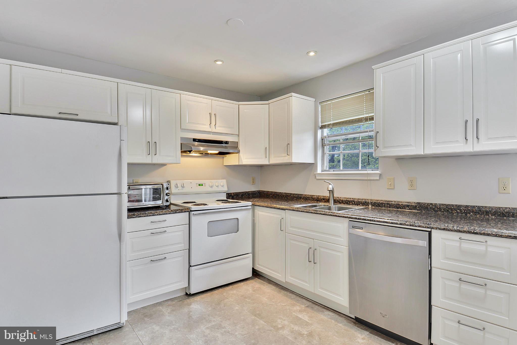 3841 Ferrara Drive Silver Spring, MD 20906 - Photo 3 of 30 a kitchen with appliances a sink and cabinets