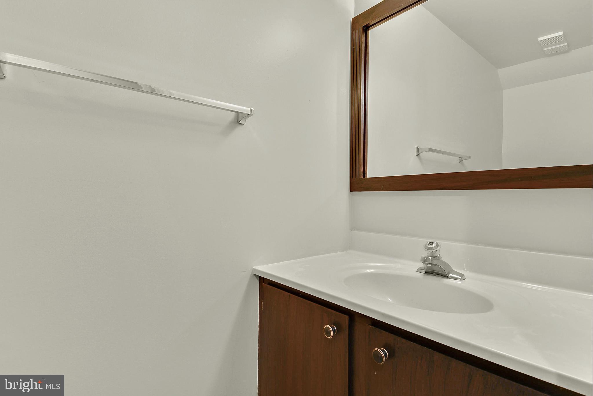3841 Ferrara Drive Silver Spring, MD 20906 - Photo 24 of 30 a bathroom with a sink and a mirror