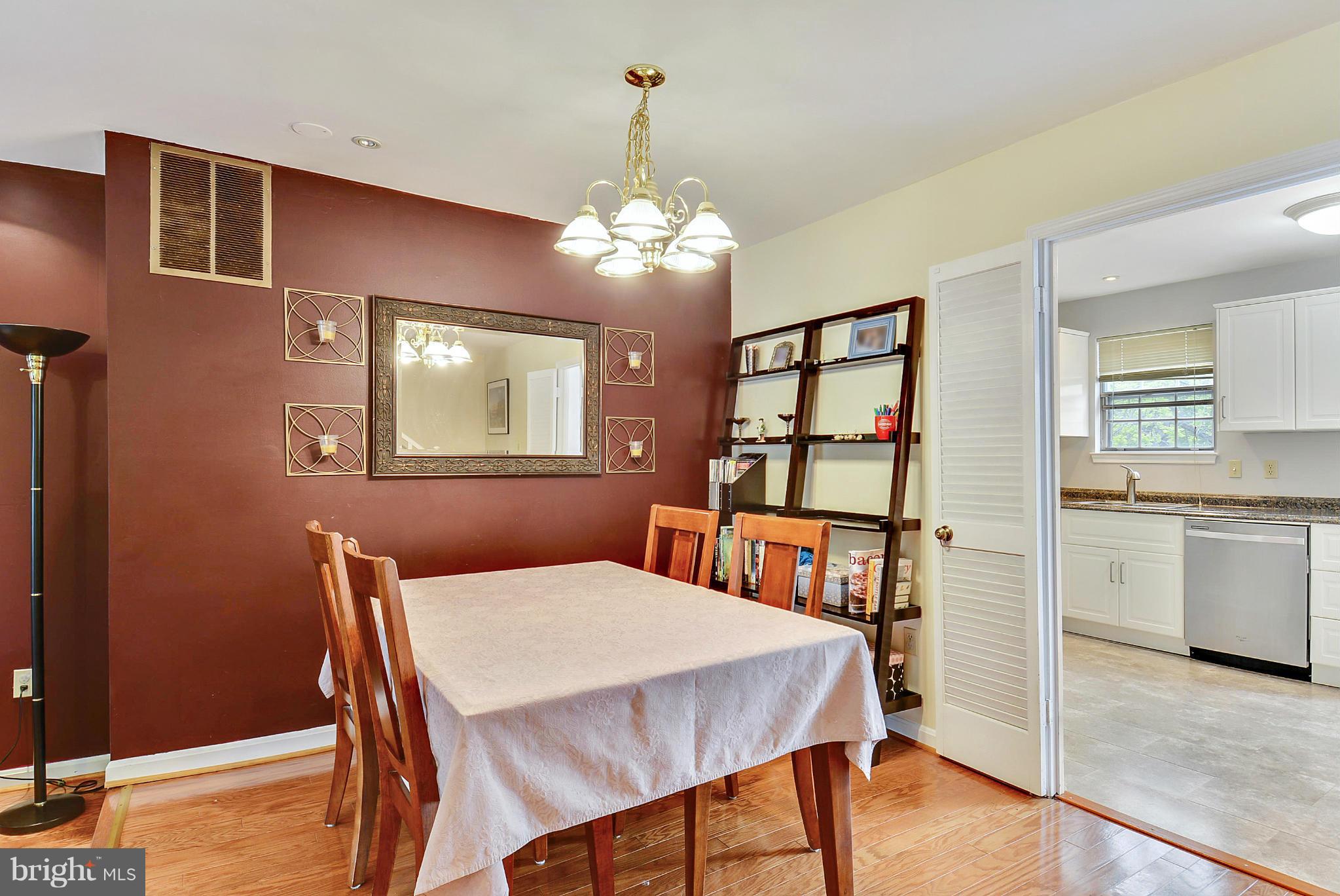 3841 Ferrara Drive Silver Spring, MD 20906 - Photo 8 of 30 a view of a dining room with furniture and chandelier