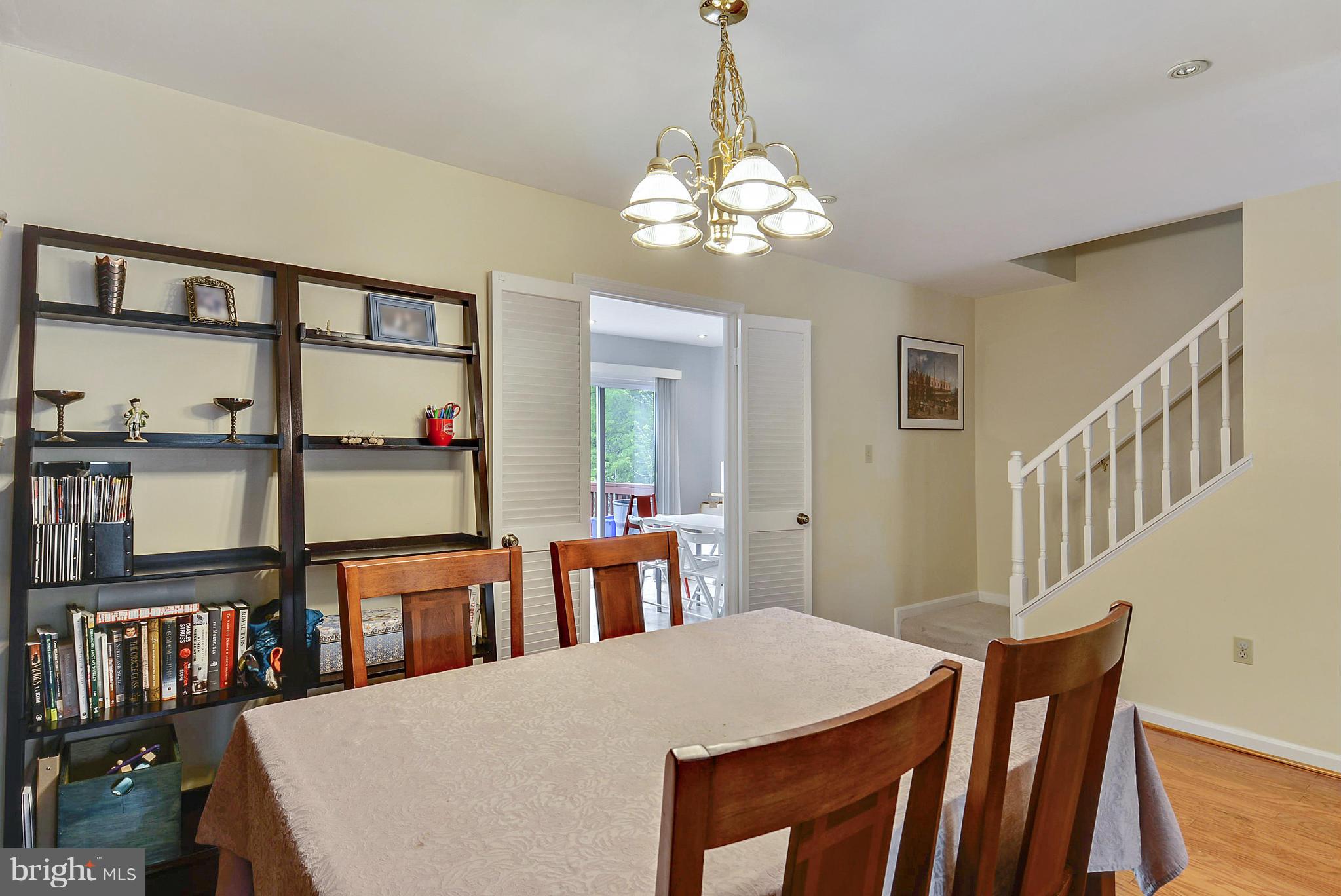 3841 Ferrara Drive Silver Spring, MD 20906 - Photo 9 of 30 a view of a dining room with furniture and a book shelf