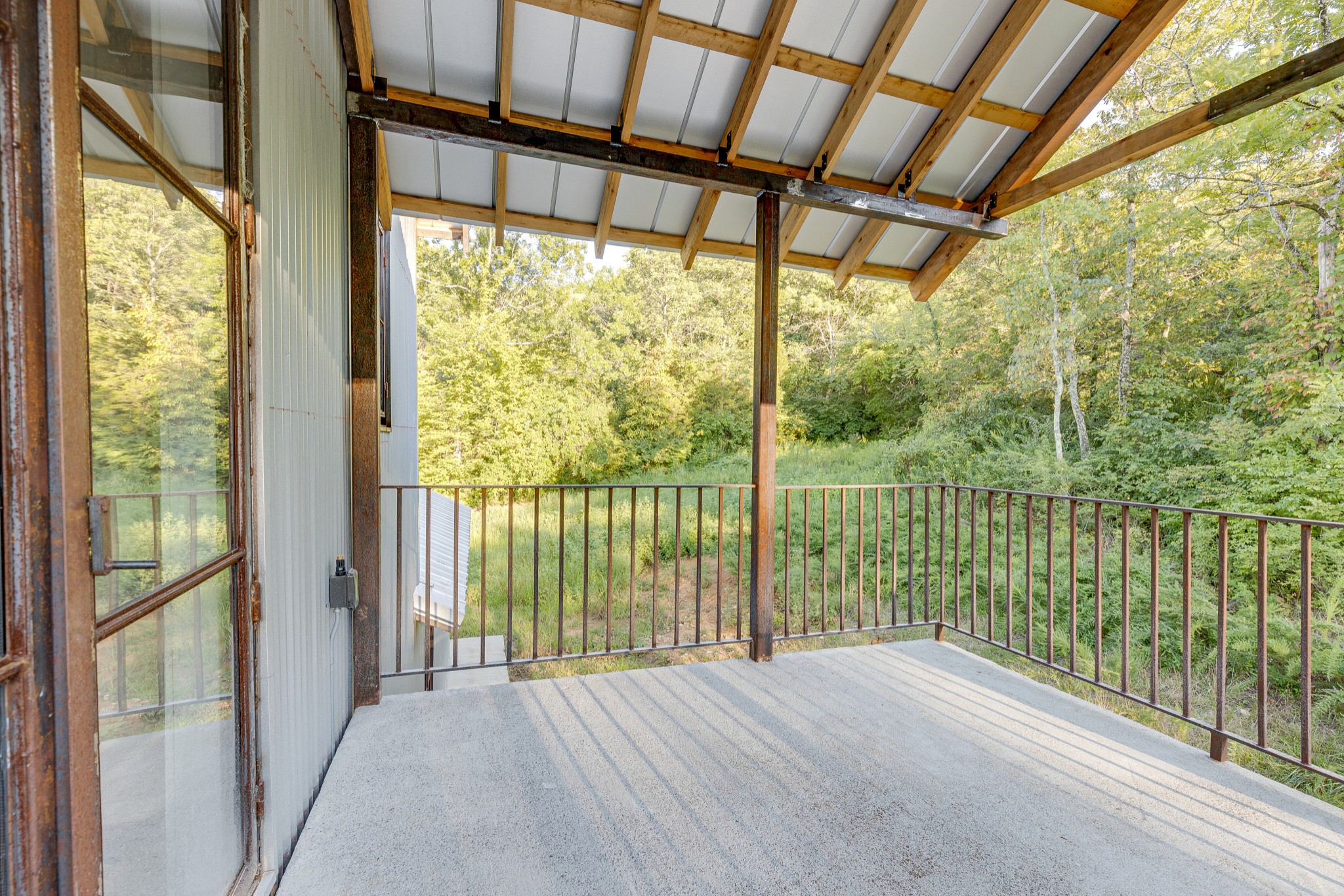 3235 Boyd Mill Pike Franklin, TN 37064 - Photo 29 of 68 a view of an empty room with wooden floor and a porch