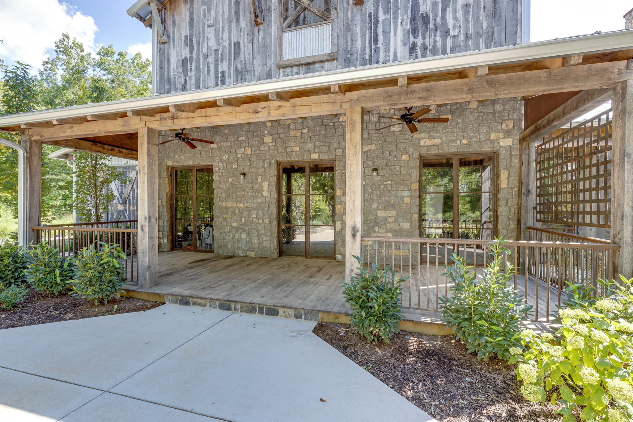 3235 Boyd Mill Pike Franklin, TN 37064 - Photo 3 of 68 This is truly a totally custom home with stone, white oak and metal exterior finishes. The lattice work on the right side of the porch is hand welded metal.