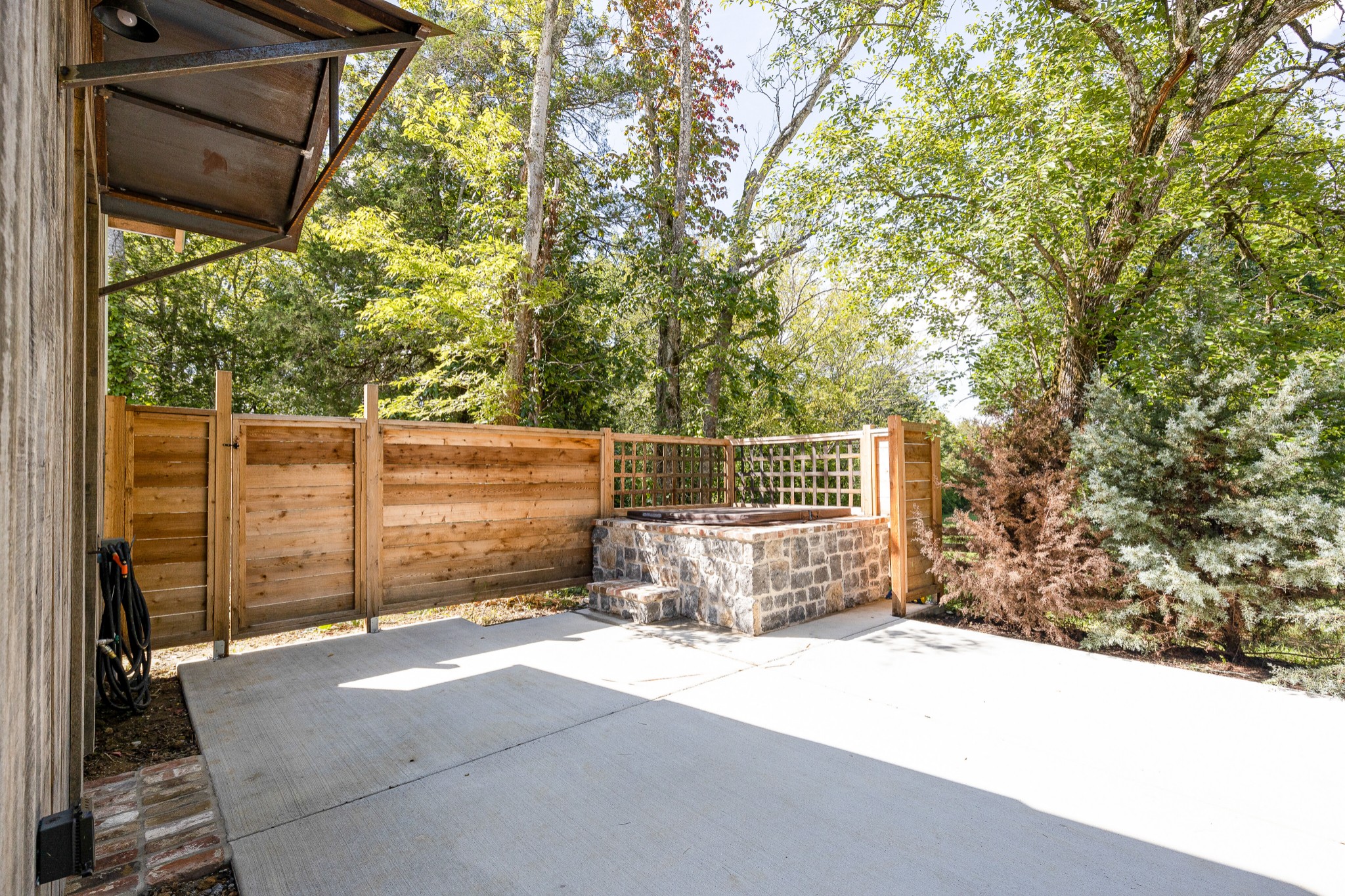 3235 Boyd Mill Pike Franklin, TN 37064 - Photo 33 of 68 a backyard of a house with a large tree and wall