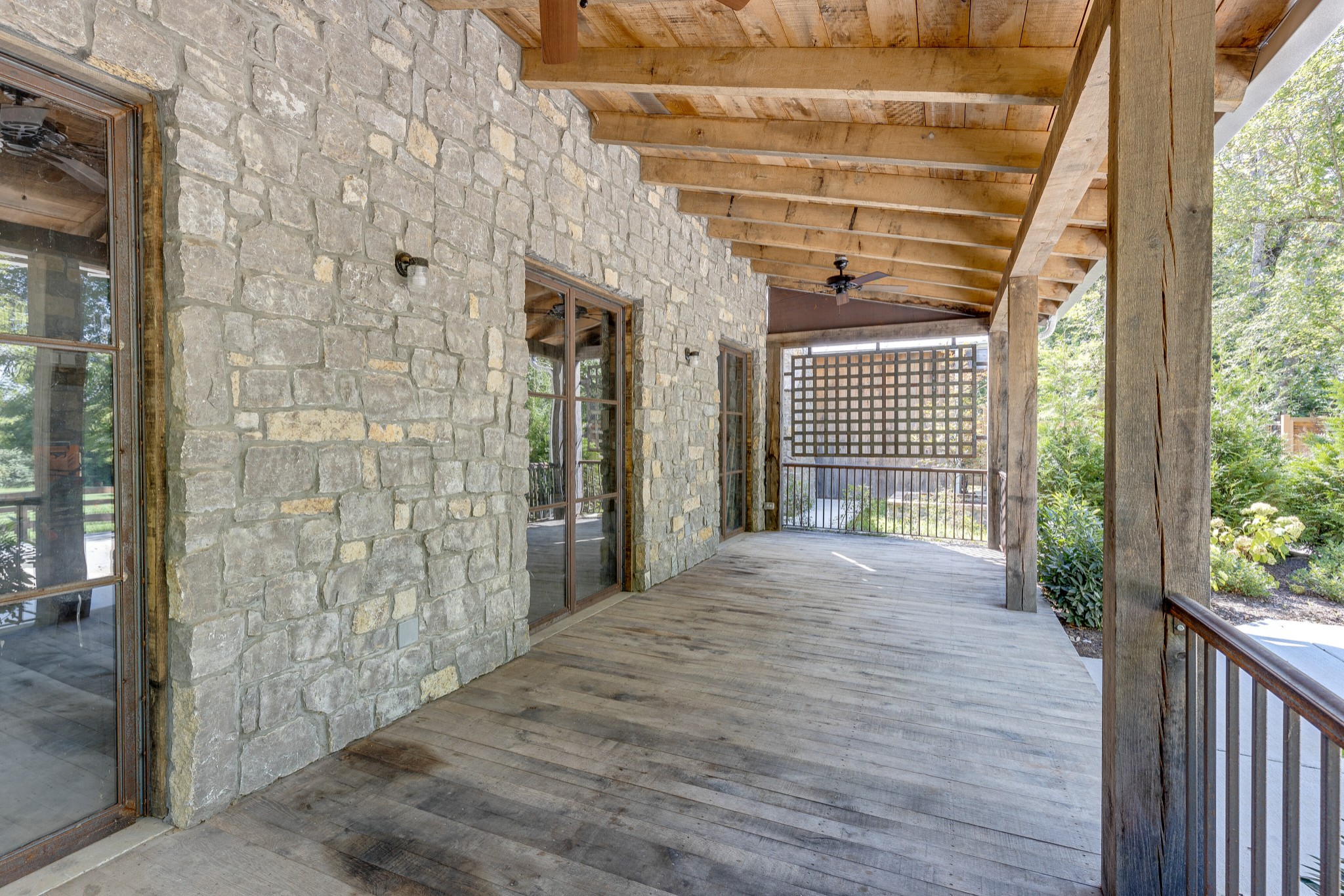 3235 Boyd Mill Pike Franklin, TN 37064 - Photo 4 of 68 a view of a porch with wooden floor and a gate