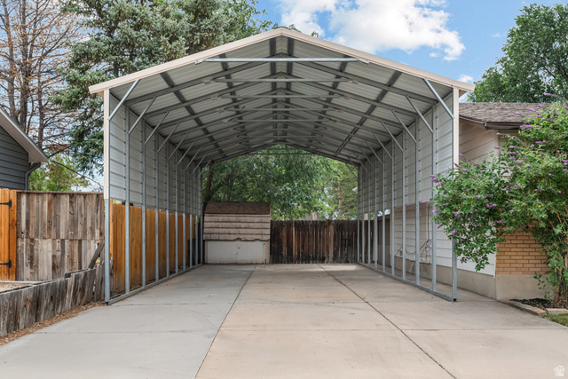 7659 State Street Midvale, UT 84047 - Photo 32 of 33 Extended carport structure with a metal roof and side panels