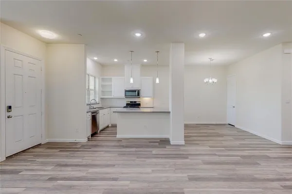a view of kitchen with kitchen island sink and refrigerator
