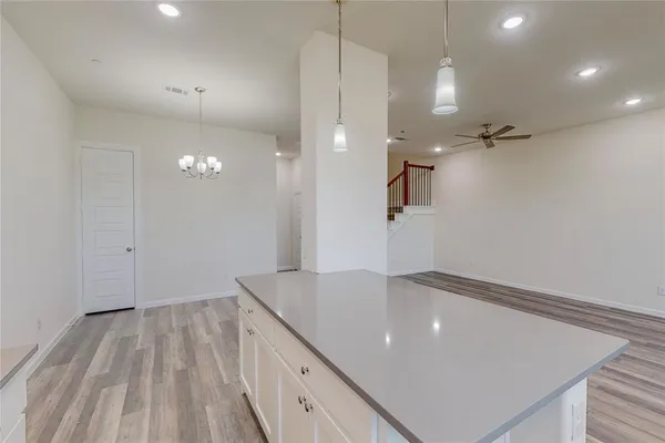 a view of a kitchen with a sink and refrigerator