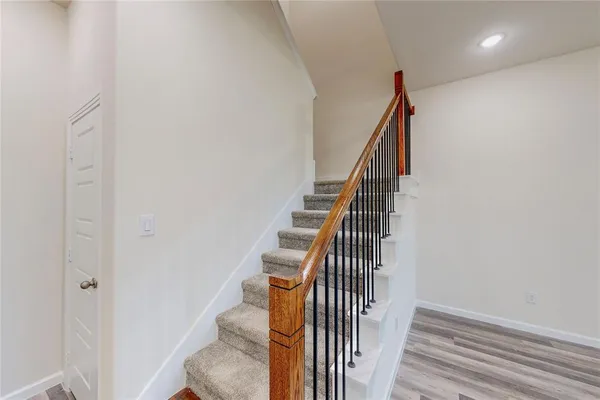 a view of entryway and hall with wooden floor