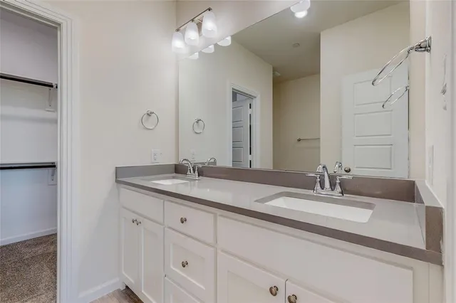 a bathroom with double vanity sinks and a mirror