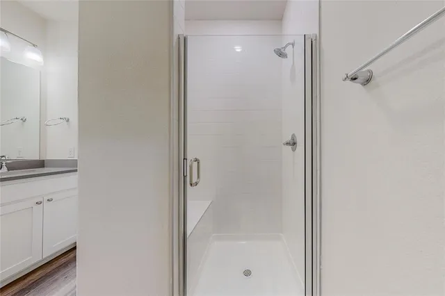 a bathroom with a glass shower door
