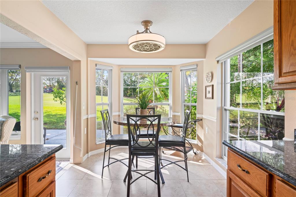 7112 Green Abbey Way Spring Hill, FL 34606 - Photo 16 of 66 a view of a dining room with furniture window and outside view