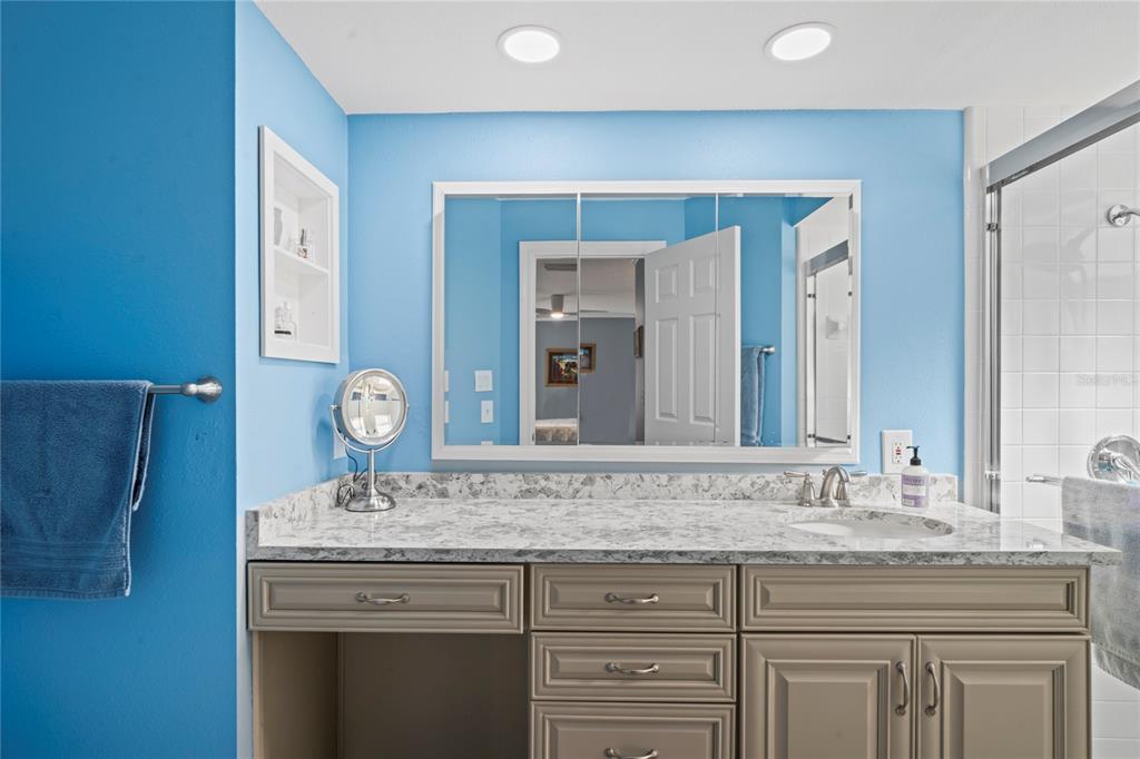 7112 Green Abbey Way Spring Hill, FL 34606 - Photo 27 of 66 a bathroom with a granite countertop sink and a mirror