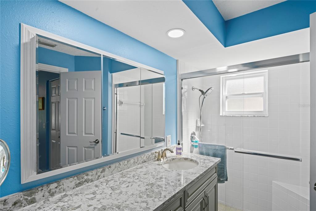 7112 Green Abbey Way Spring Hill, FL 34606 - Photo 28 of 66 a bathroom with a granite countertop sink and a mirror