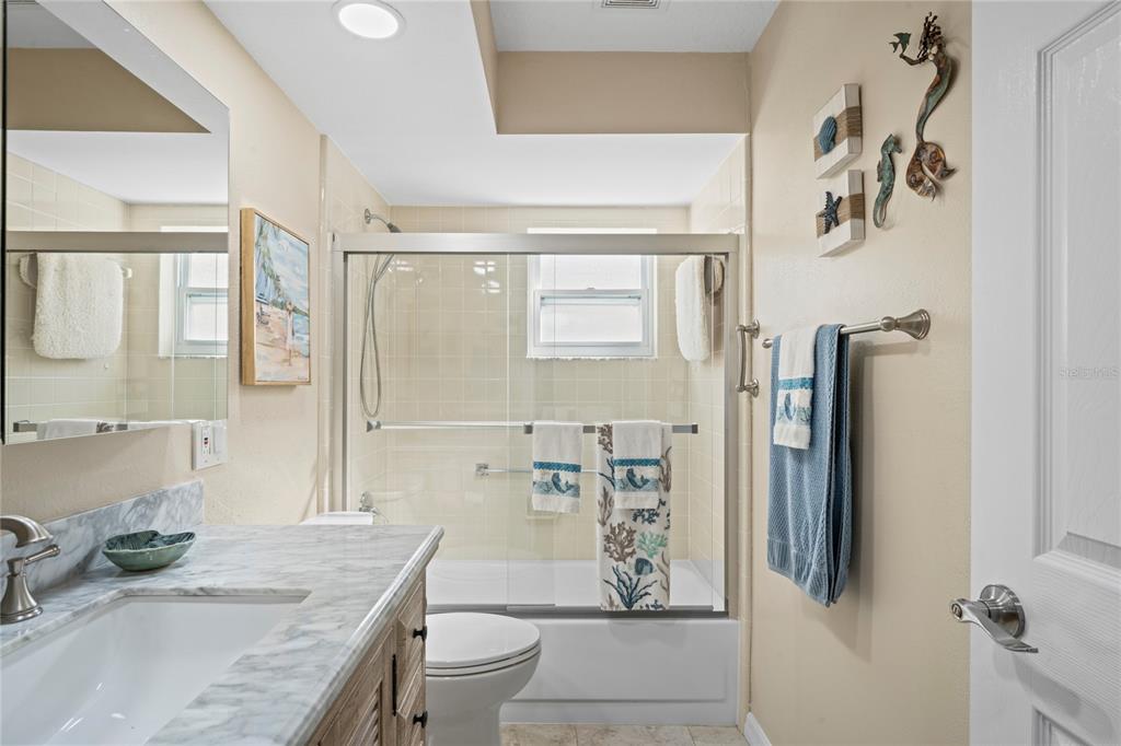 7112 Green Abbey Way Spring Hill, FL 34606 - Photo 33 of 66 a bathroom with a granite countertop sink a toilet and shower