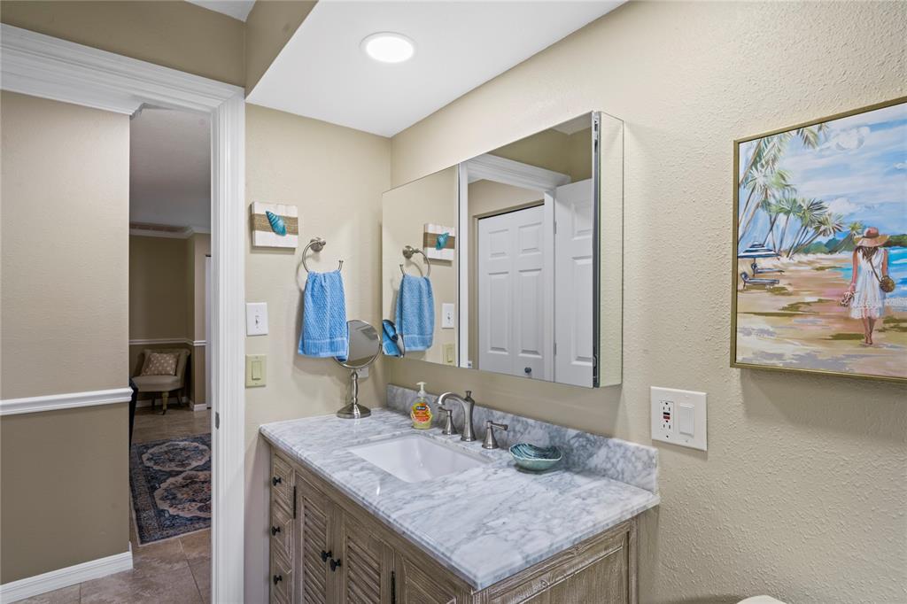 7112 Green Abbey Way Spring Hill, FL 34606 - Photo 34 of 66 a bathroom with a granite countertop sink and a mirror