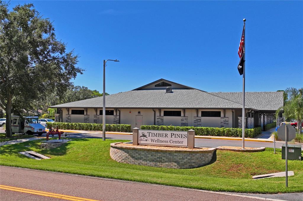 7112 Green Abbey Way Spring Hill, FL 34606 - Photo 63 of 66 a front view of a house with a yard table and chairs