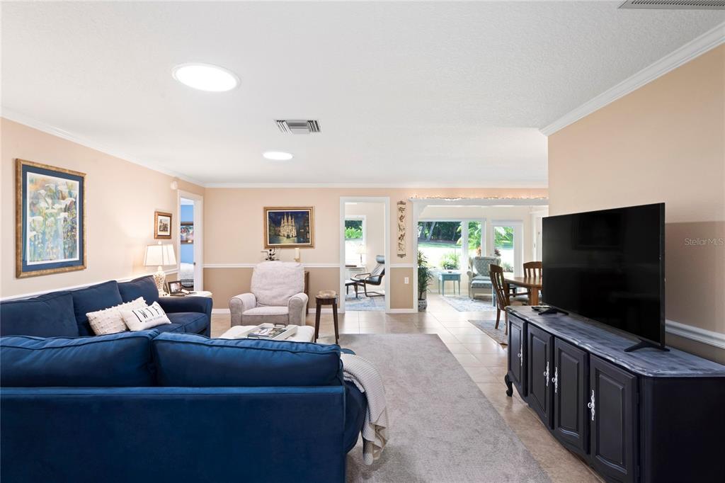 7112 Green Abbey Way Spring Hill, FL 34606 - Photo 9 of 66 a living room with furniture and a flat screen tv