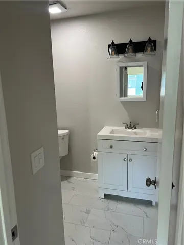 a bathroom with a sink toilet and mirror
