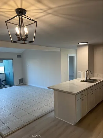 a room with a sink and chandelier