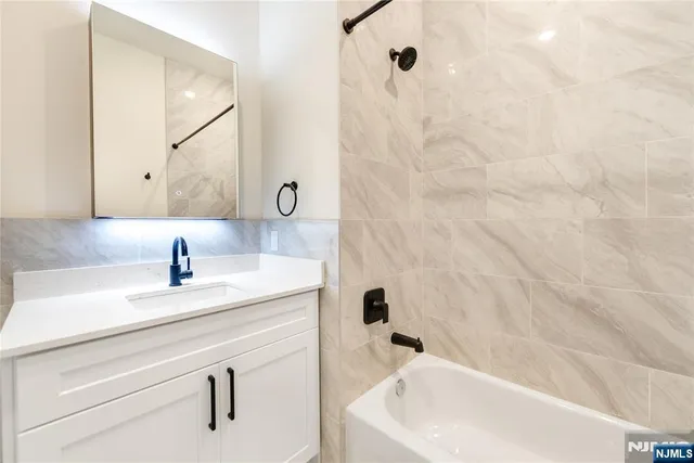 a bathroom with a sink and mirror