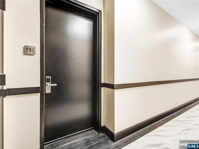 a kitchen with stainless steel appliances a refrigerator sink and white cabinets
