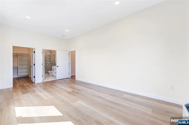 a view of walk in closet with empty racks