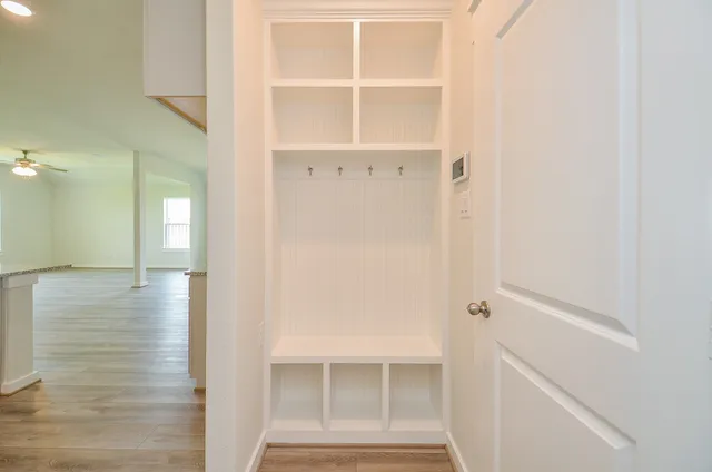 a view of walk in closet with empty racks