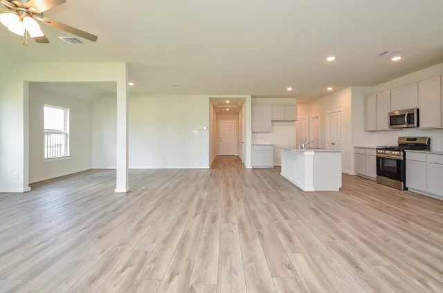 a view of kitchen with sink and refrigerator