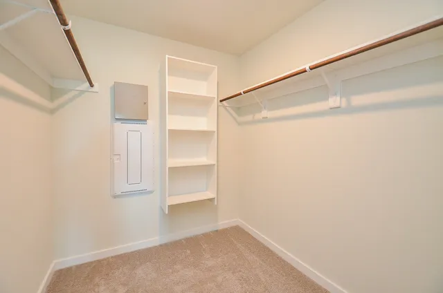 a view of walk in closet with empty racks