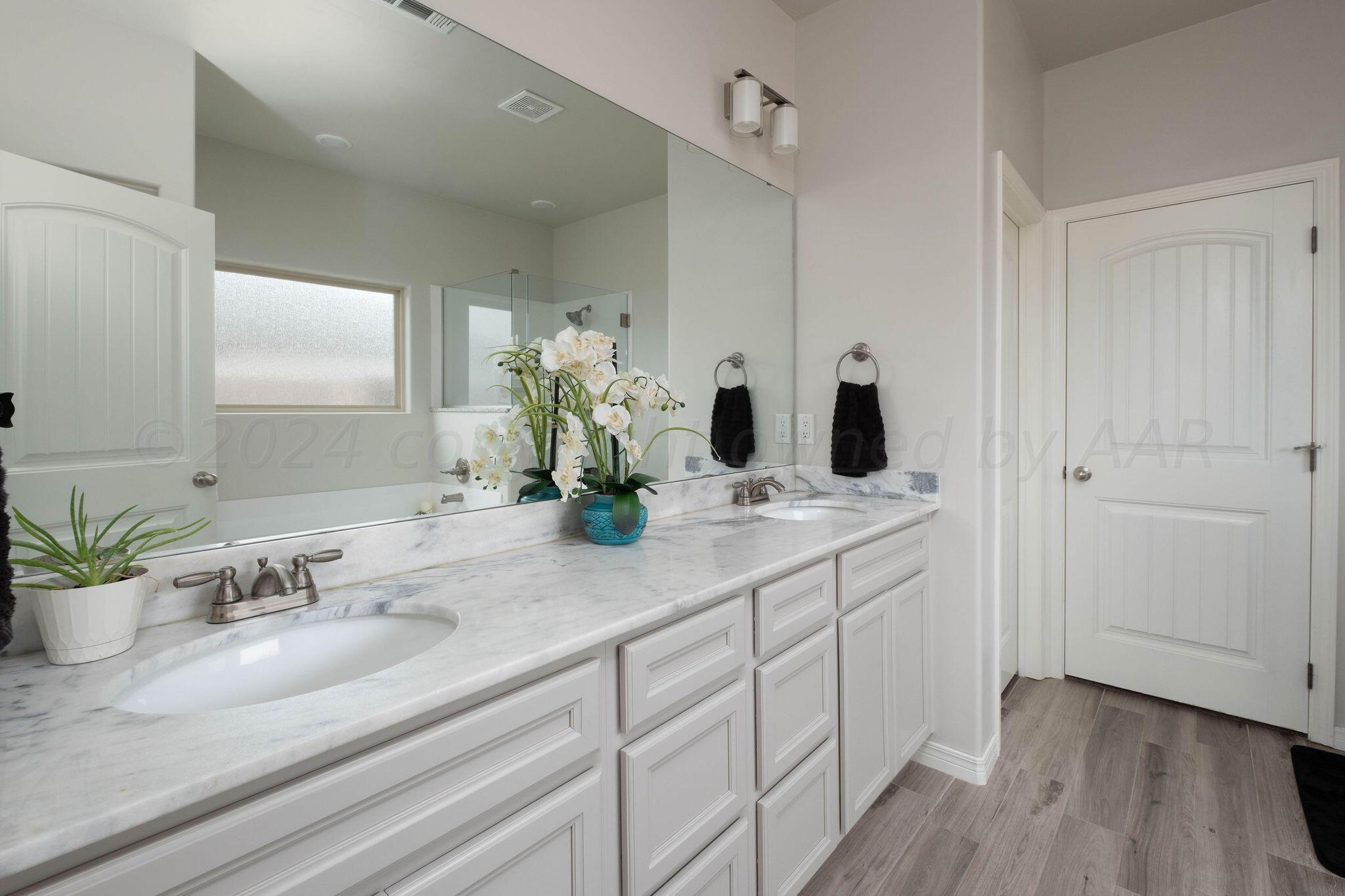 1009 Syrah Boulevard Amarillo, TX 79124 - Photo 19 of 35 a bathroom with double vanity sink and a mirror