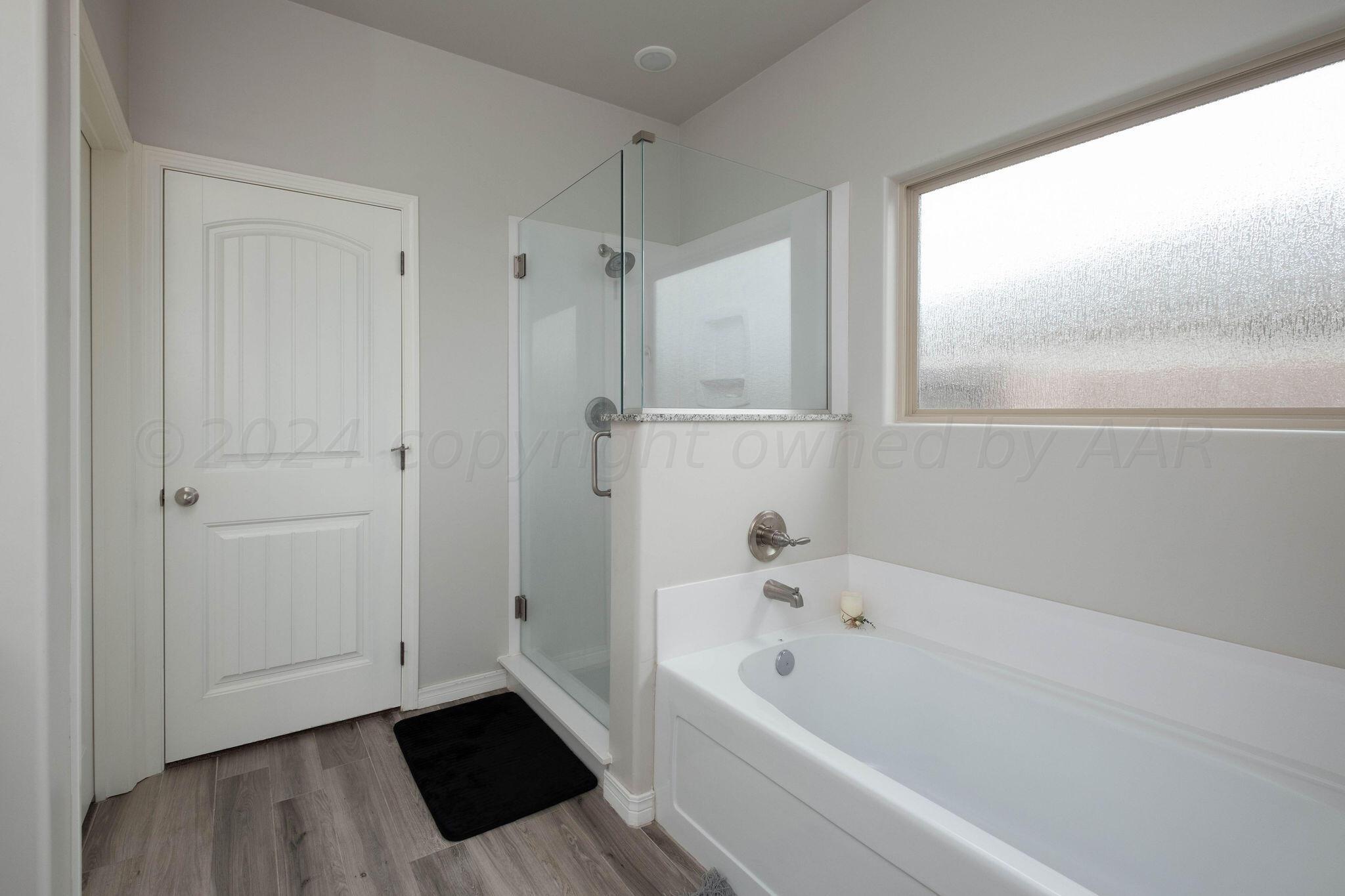 1009 Syrah Boulevard Amarillo, TX 79124 - Photo 20 of 35 a bathroom with a bathtub and a shower