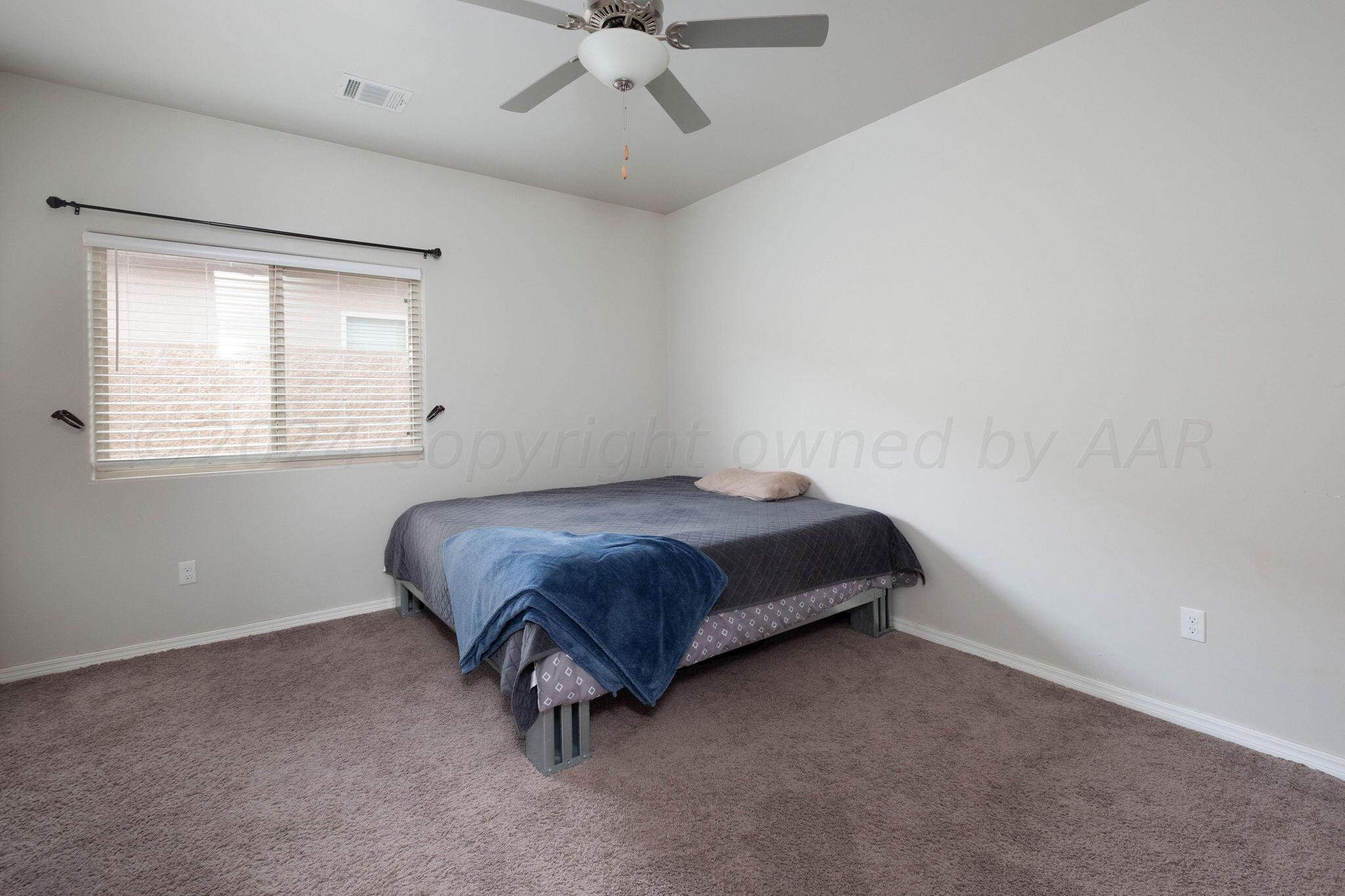 1009 Syrah Boulevard Amarillo, TX 79124 - Photo 28 of 35 a bedroom with a bed and window