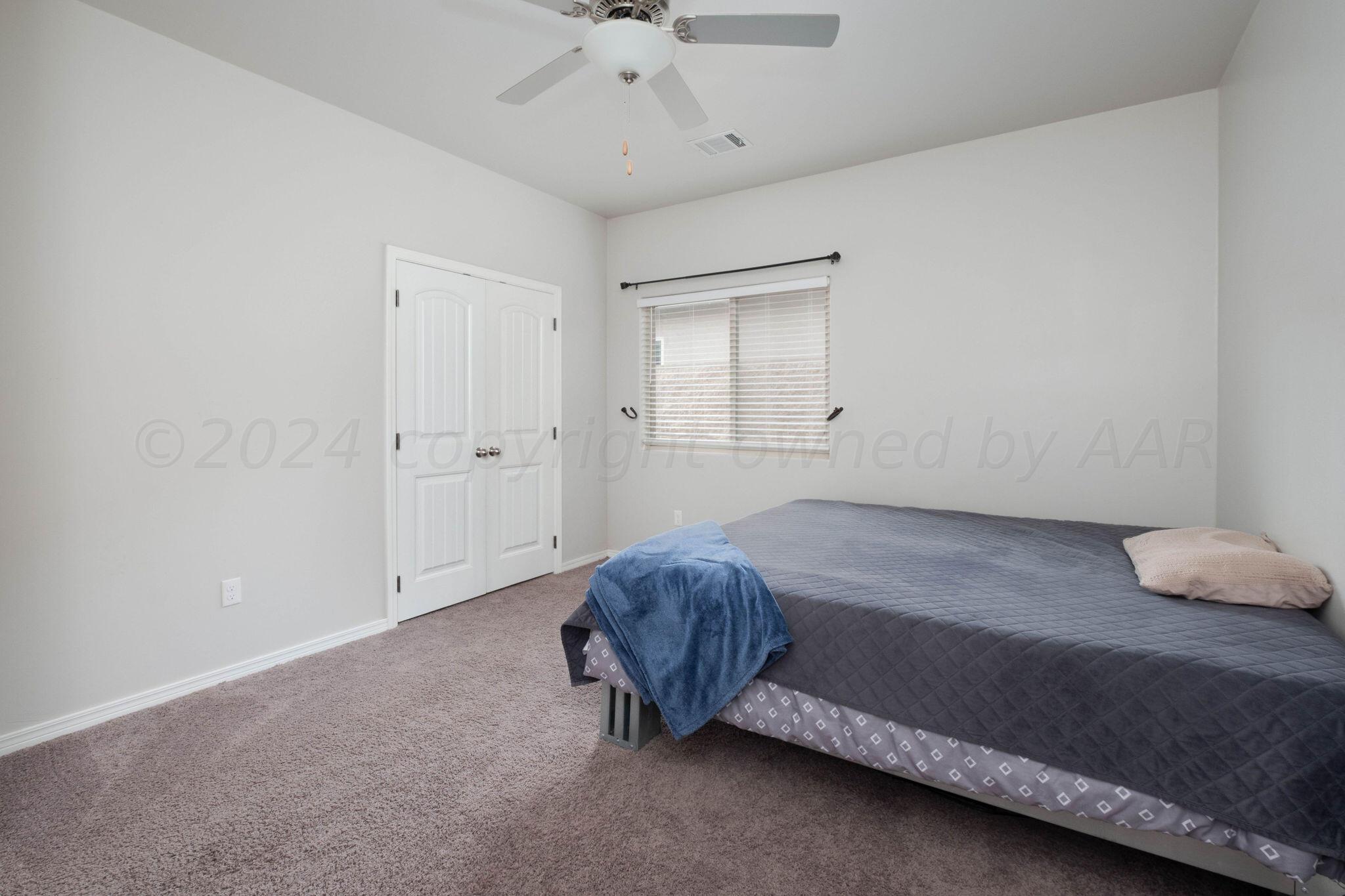 1009 Syrah Boulevard Amarillo, TX 79124 - Photo 29 of 35 a bedroom with a bed and a ceiling fan