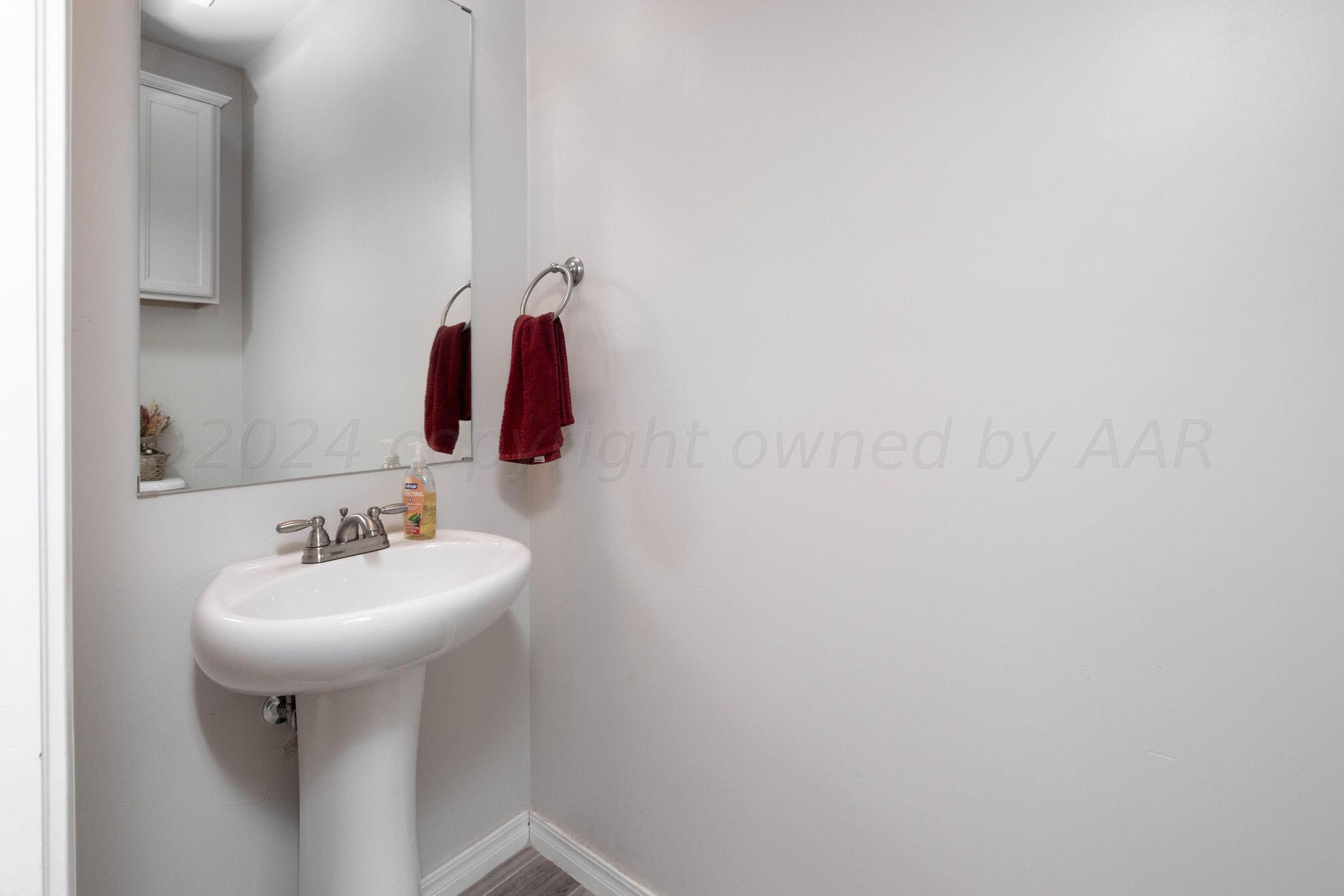 1009 Syrah Boulevard Amarillo, TX 79124 - Photo 32 of 35 a bathroom with a sink and mirror