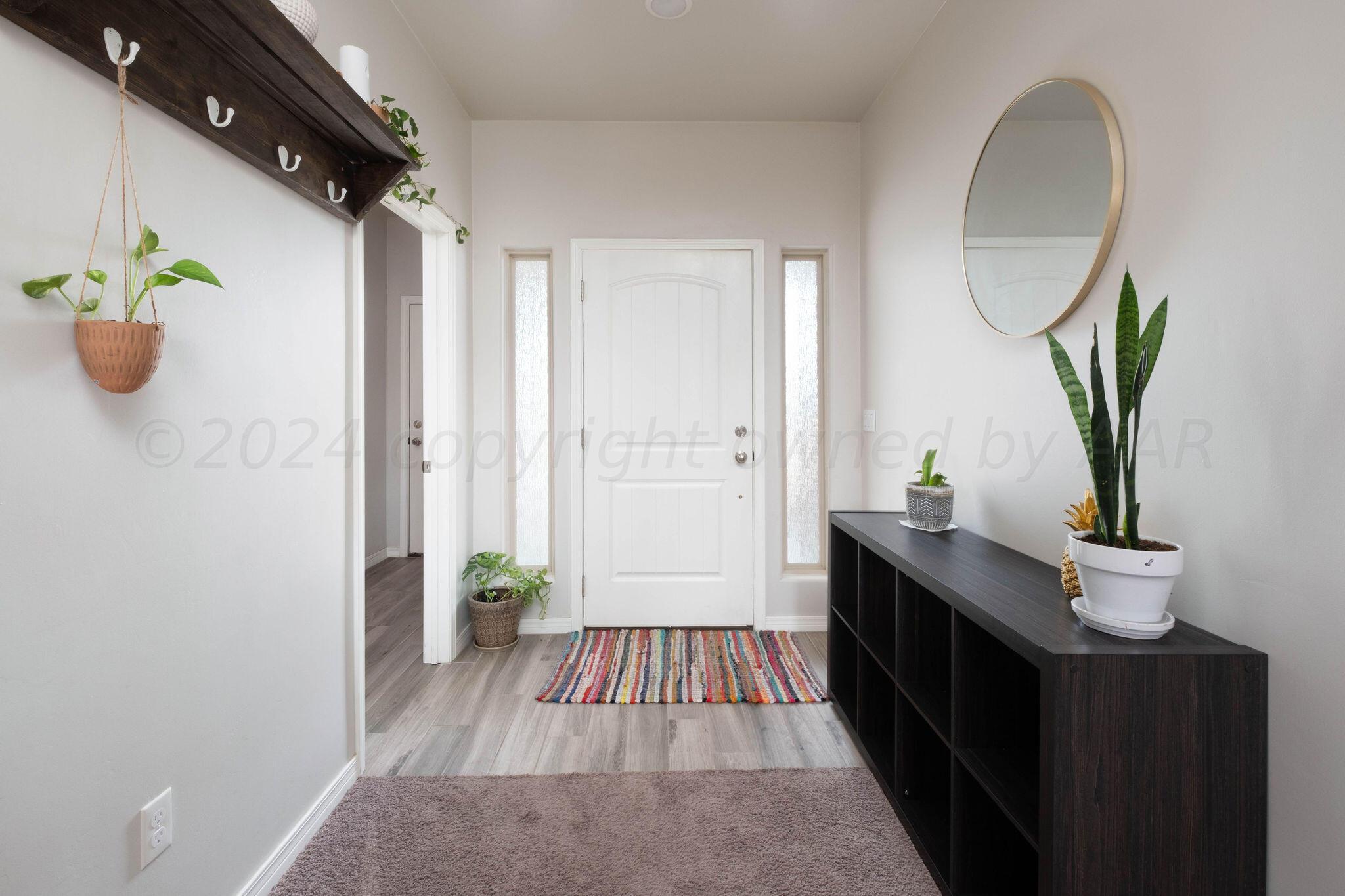 1009 Syrah Boulevard Amarillo, TX 79124 - Photo 5 of 35 a view of hallway with wooden floor