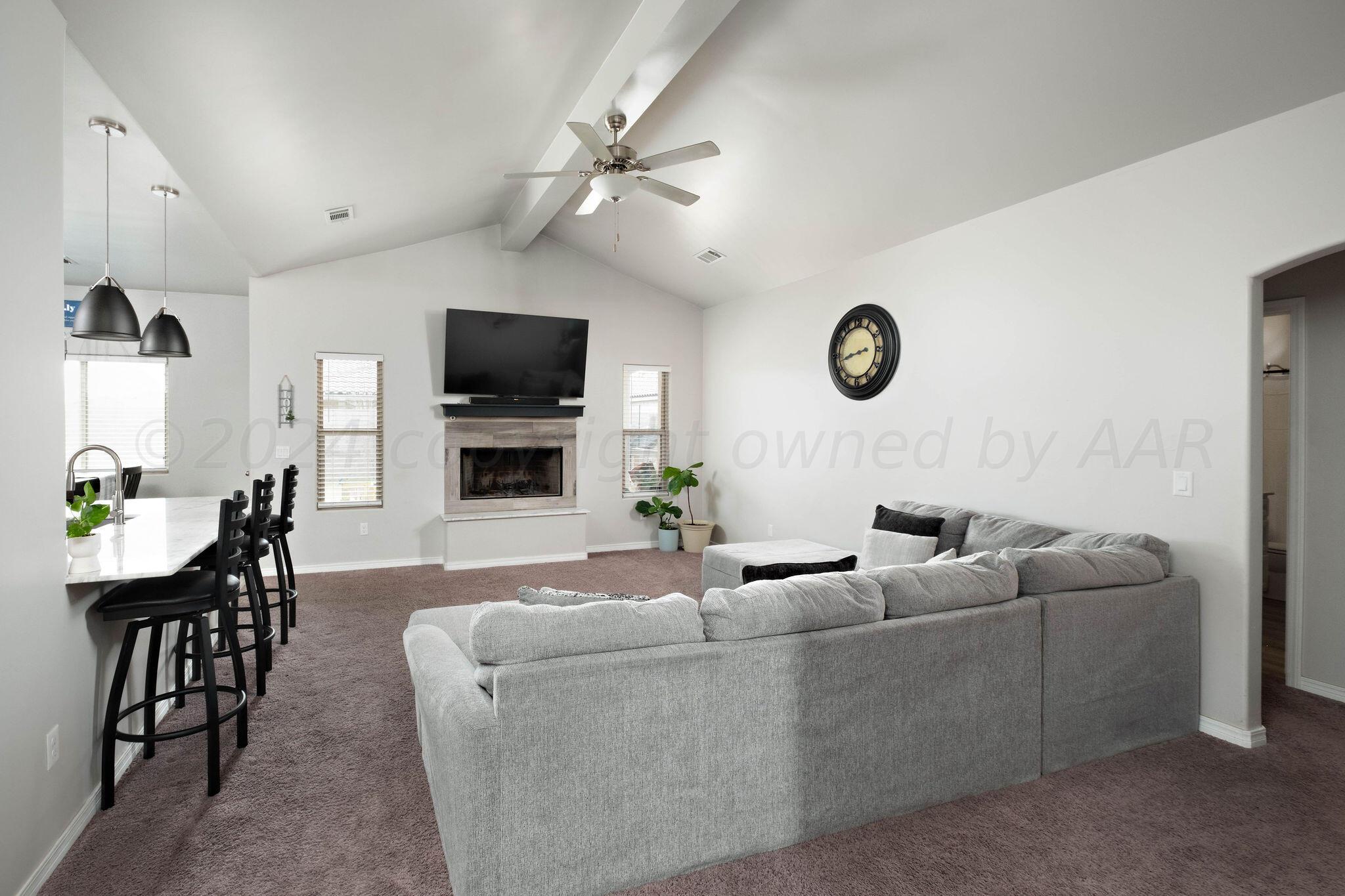1009 Syrah Boulevard Amarillo, TX 79124 - Photo 6 of 35 a living room with furniture a flat screen tv and a fireplace