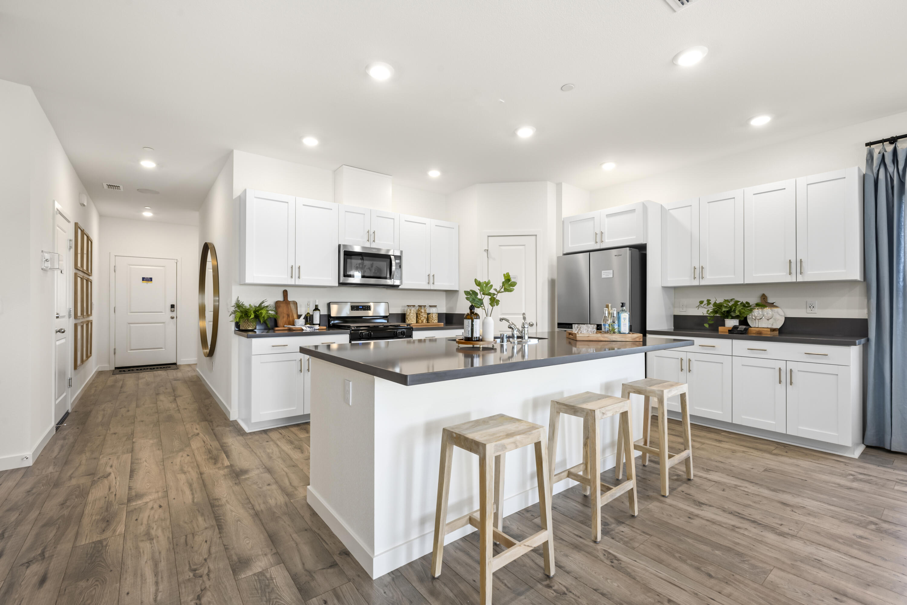 5237 Monaco Parkway Redding, CA 96002 - Photo 3 of 7 a kitchen with white cabinets and stainless steel appliances