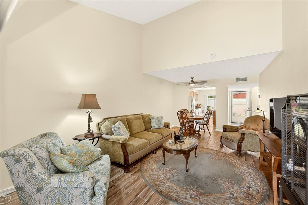 2064 Sunset Point Road, Unit 73 Clearwater, FL 33765 - Photo 11 of 58 a living room with furniture and a lamp