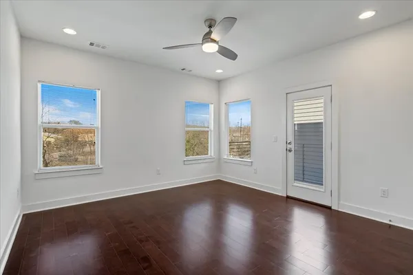a bedroom with a bed a couch and potted plant with the dresser