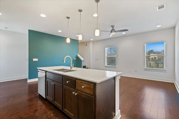 a view of kitchen with kitchen island refrigerator sink and stove