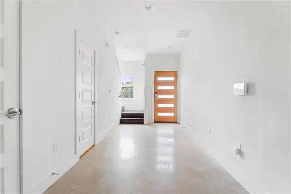 a kitchen with a sink a window and wooden floor