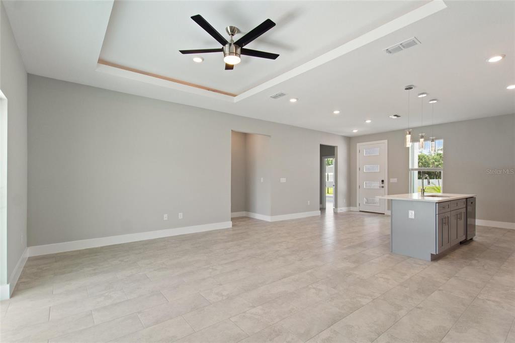 24399 Southwest Kingsway Circle Punta Gorda, FL 33983 - Photo 11 of 38 an empty room with windows and a ceiling fan
