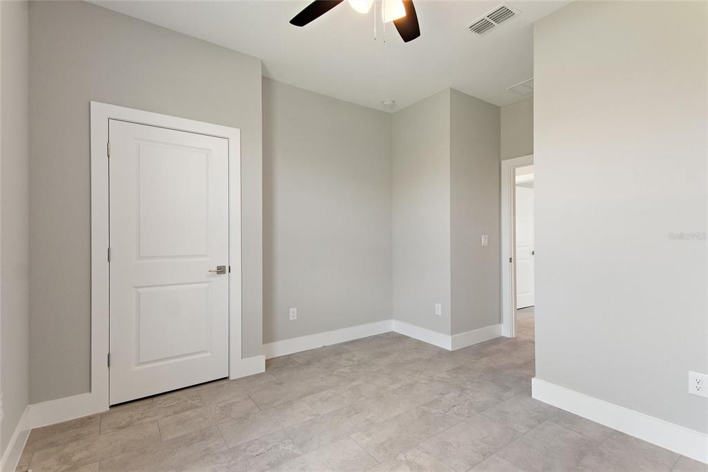 24399 Southwest Kingsway Circle Punta Gorda, FL 33983 - Photo 17 of 38 an empty room with ceiling fan