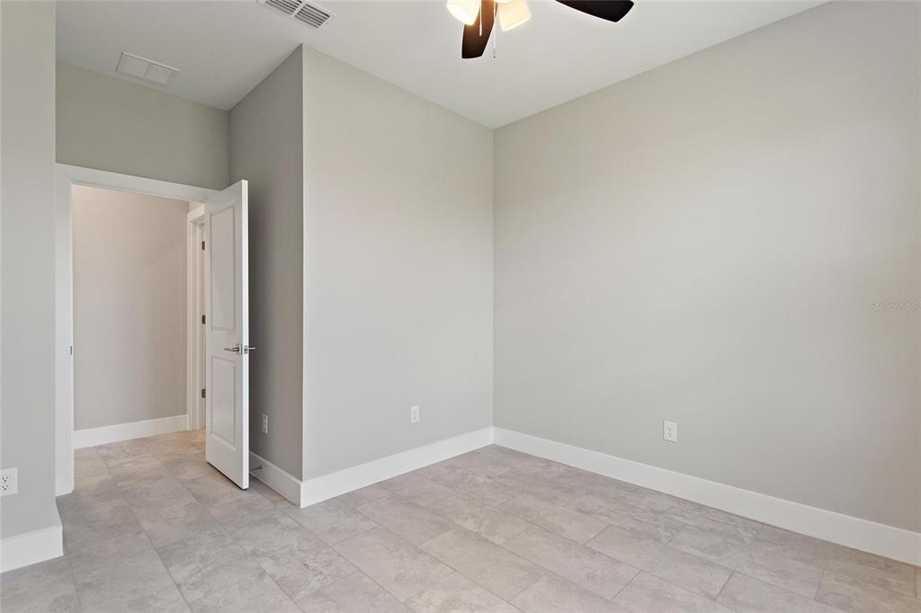 24399 Southwest Kingsway Circle Punta Gorda, FL 33983 - Photo 23 of 38 an empty room with ceiling fan