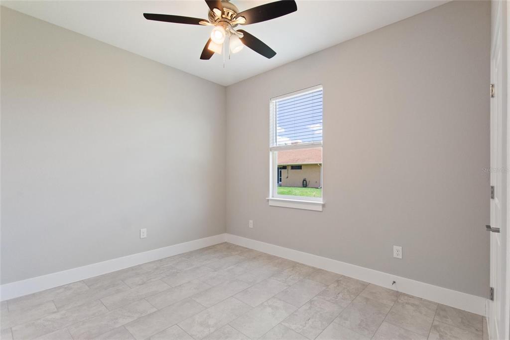 24399 Southwest Kingsway Circle Punta Gorda, FL 33983 - Photo 26 of 38 an empty room with windows and fan