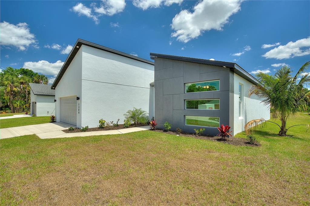 24399 Southwest Kingsway Circle Punta Gorda, FL 33983 - Photo 3 of 38 a view of an house with backyard and garage