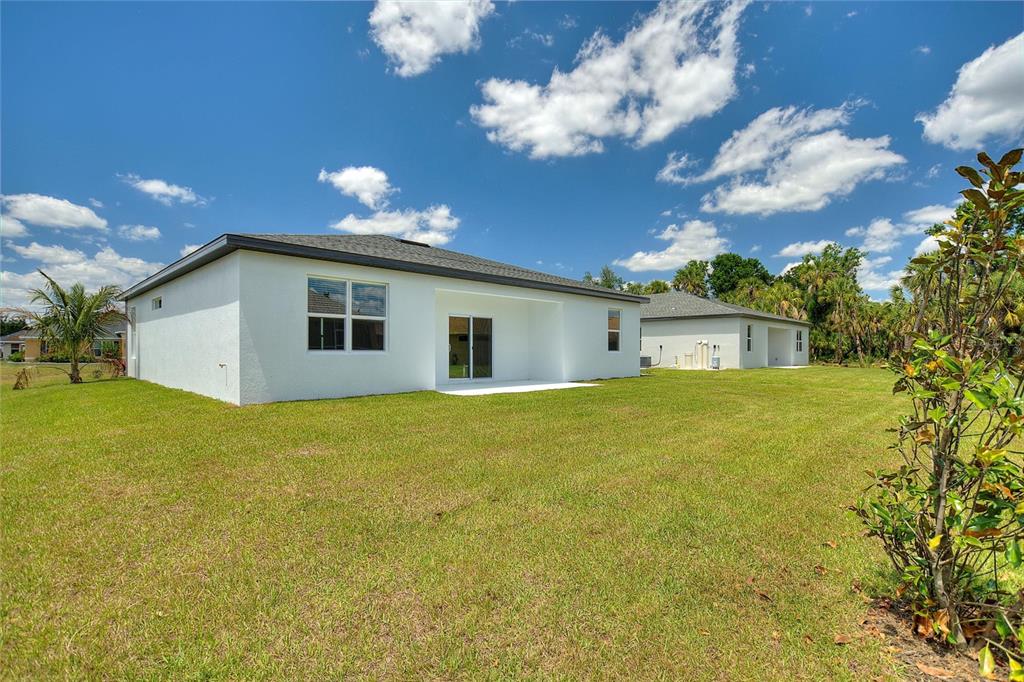 24399 Southwest Kingsway Circle Punta Gorda, FL 33983 - Photo 32 of 38 a front view of house with yard